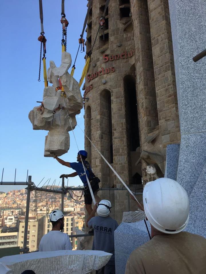 Workers place sculptures of angels in one of the facades of the Sagrada Família